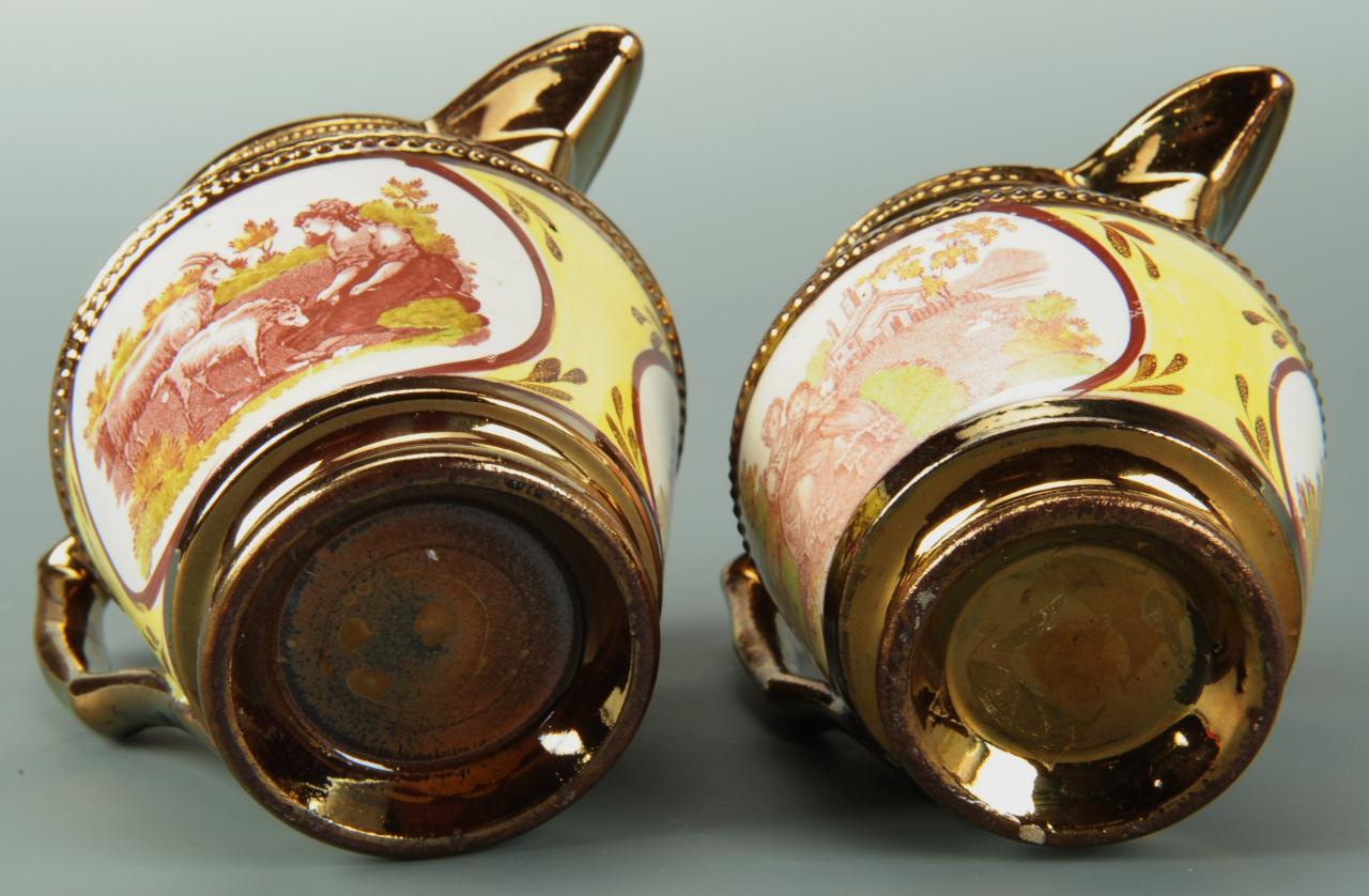 Lot 560: Four silver and copper lustre pitchers