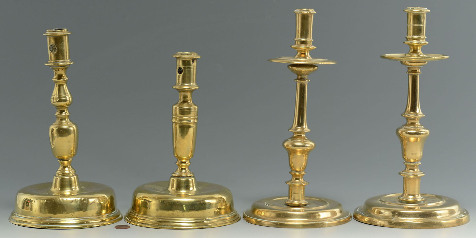 Lot 30: Four 17th c. English or Dutch Brass Candlesticks