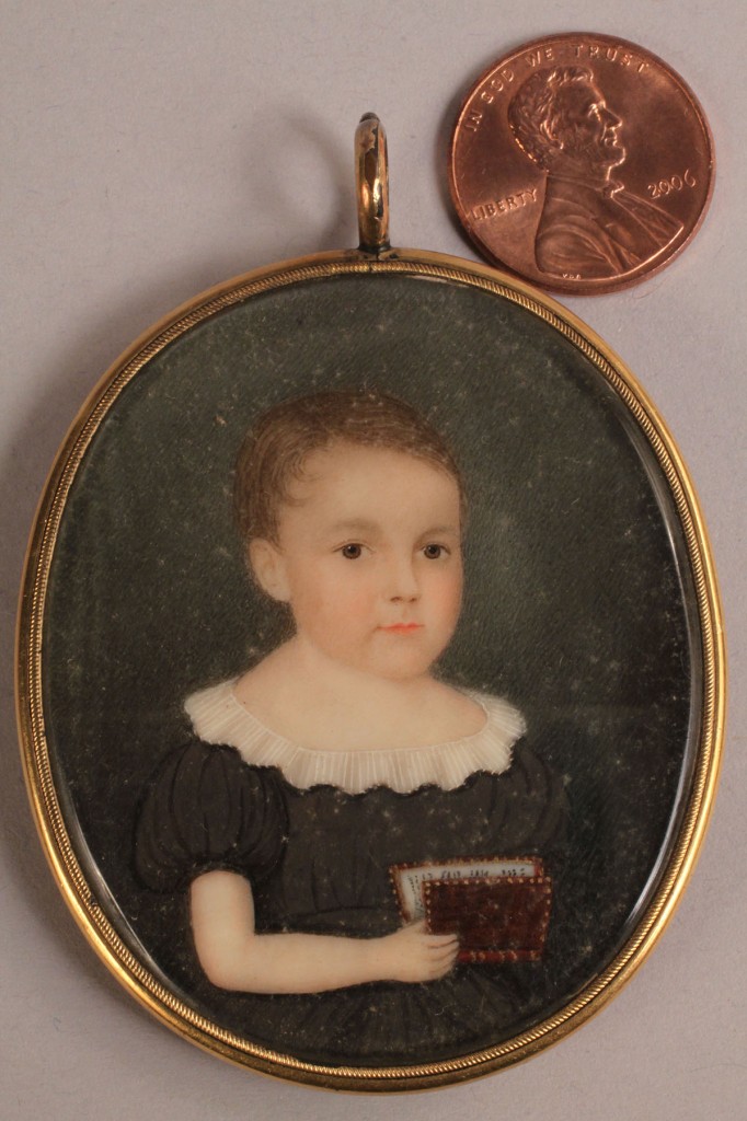 Lot 139: Portrait miniature of child with book, American School