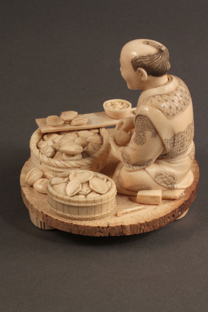 Lot 262: Ivory Japanese figure shucking clams