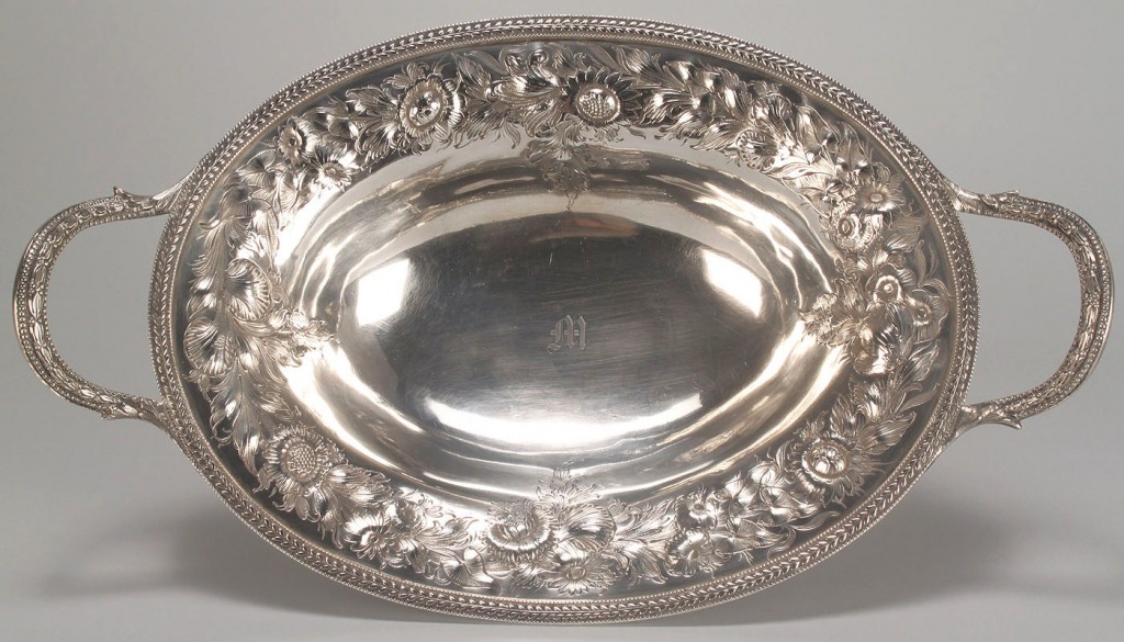 Lot 115: Coin silver repousse cake basket