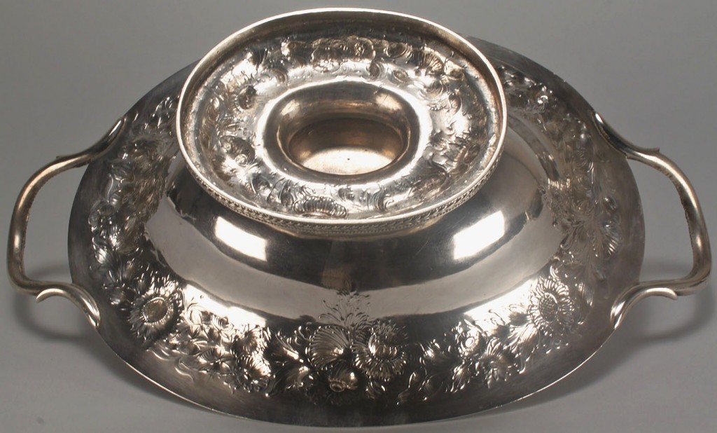 Lot 115: Coin silver repousse cake basket