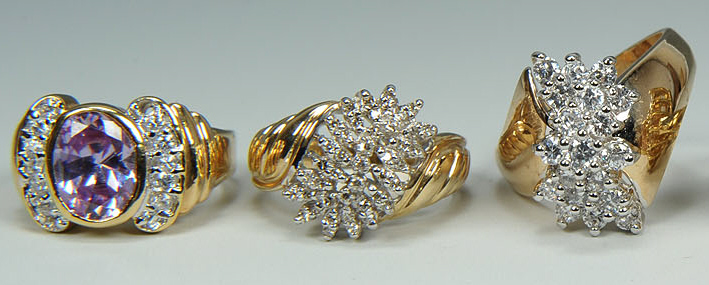 Lot 168: Group of six 10K yellow gold rings, four with diam