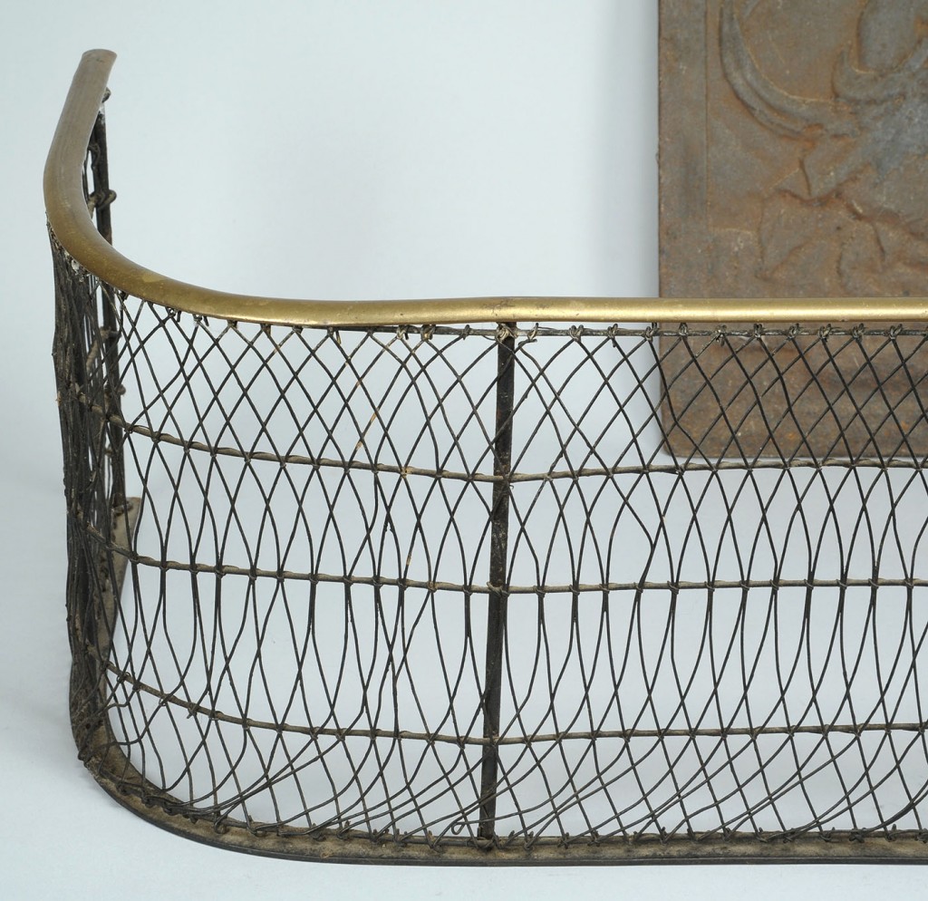 Lot 314: 18th c. Wirework fender & Cast Iron Stove plate