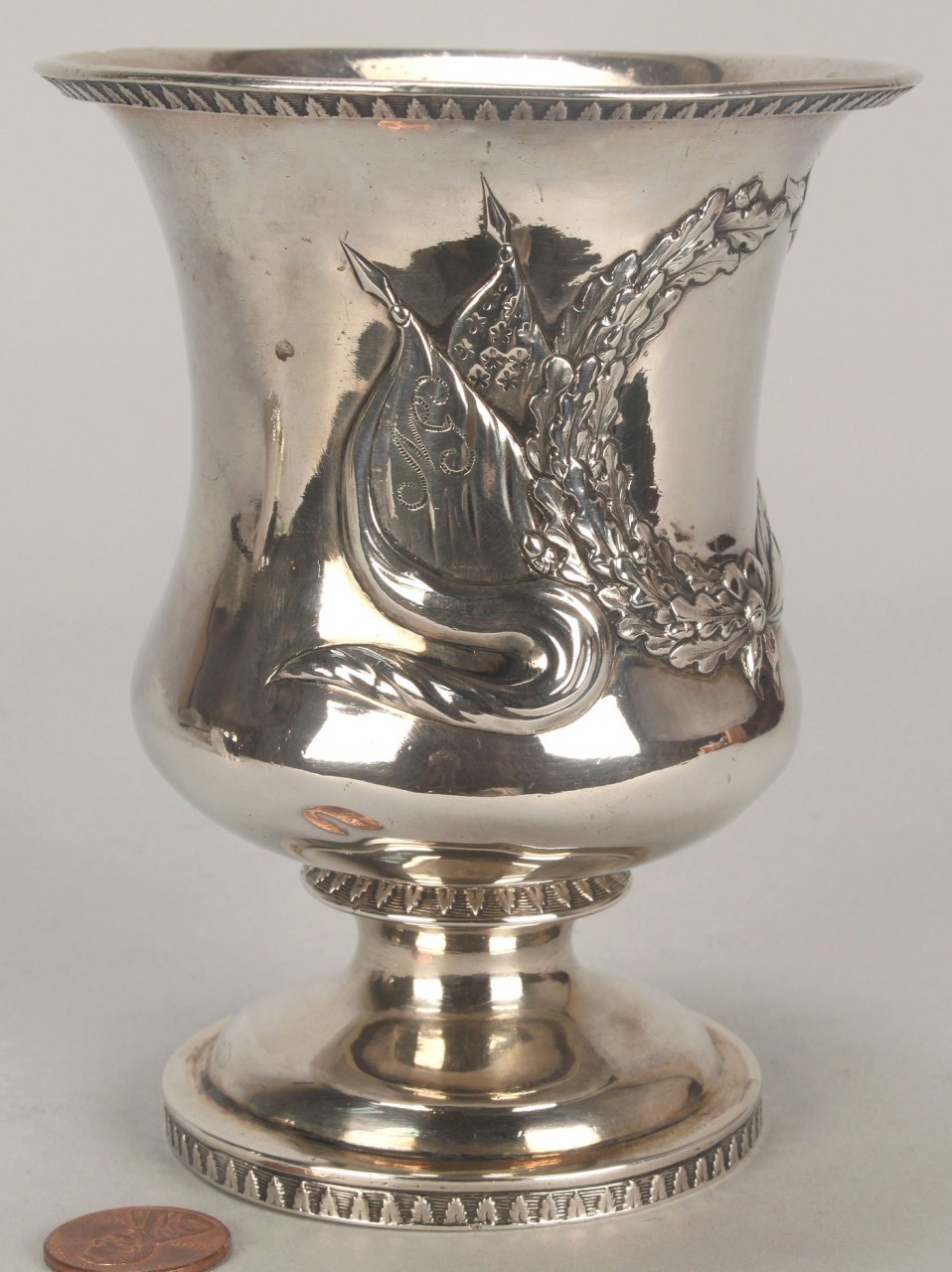 Lot 358: Coin silver cup with military design