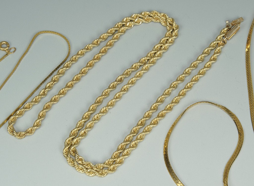 Lot 392: Group of four 14K yellow gold chains