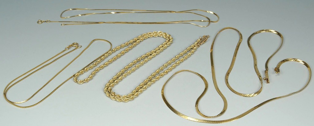 Lot 392: Group of four 14K yellow gold chains