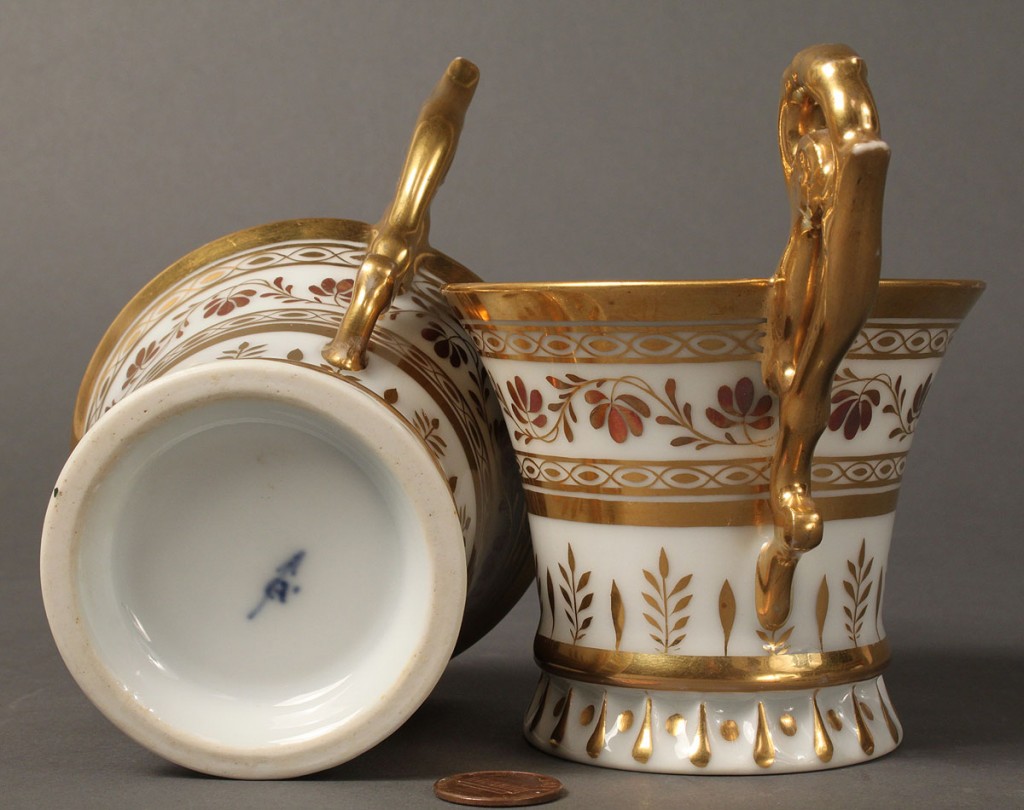 Lot 117: Pair of European figural painted teacups and saucers