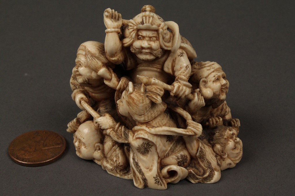 Lot 8: Ivory netsuke of 7 figures in a pile, red lacquer seal