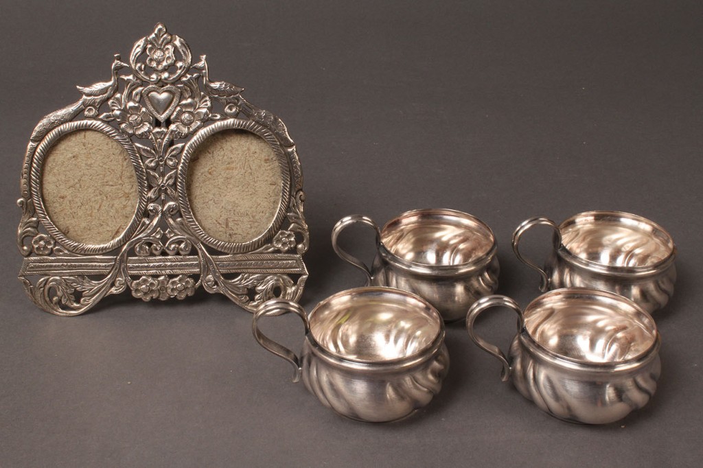 Lot 300: Sterling silver double picture frame and four cups