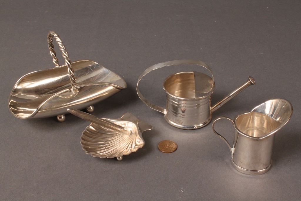 Lot 88: Four Cartier and Tiffany Sterling Silver novelties
