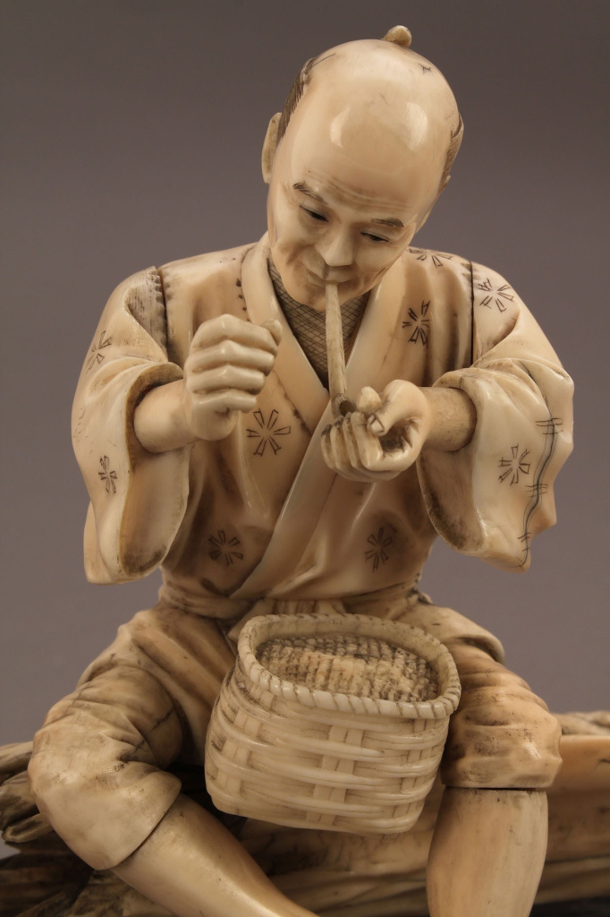 Lot 13: Ivory Okimono figure, man smoking a pipe