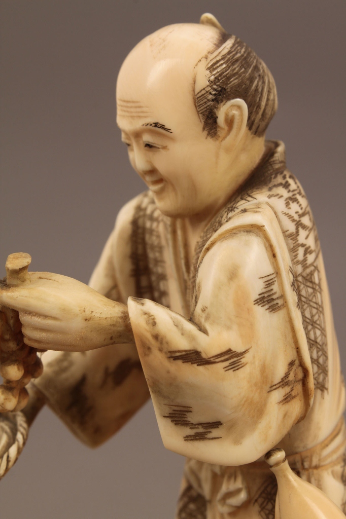 Lot 245: Ivory Okimono figure, Fruit and Vegetable Seller