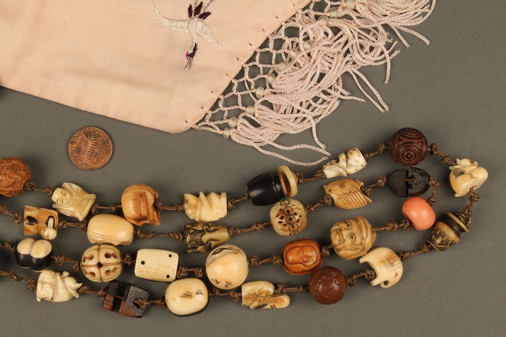 Lot 246: Collection of 52 Asian Ojime beads w/ Silk Pouch