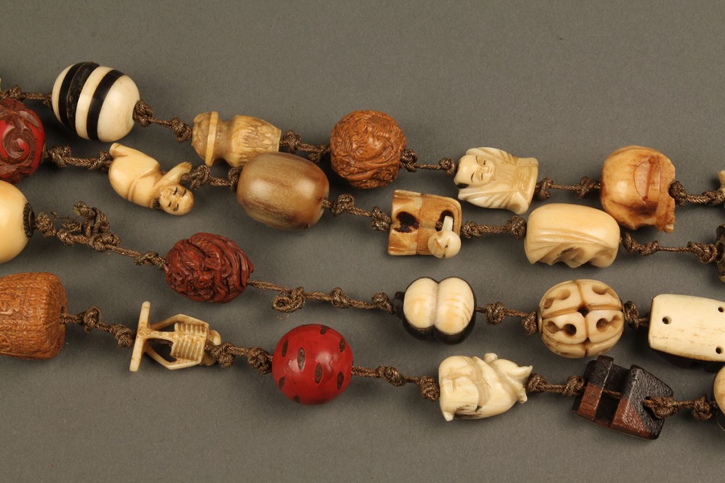 Lot 246: Collection of 52 Asian Ojime beads w/ Silk Pouch