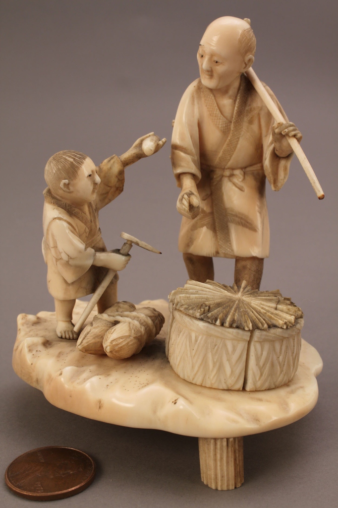 Lot 251: Ivory Okimono figure, man and boy working in the f