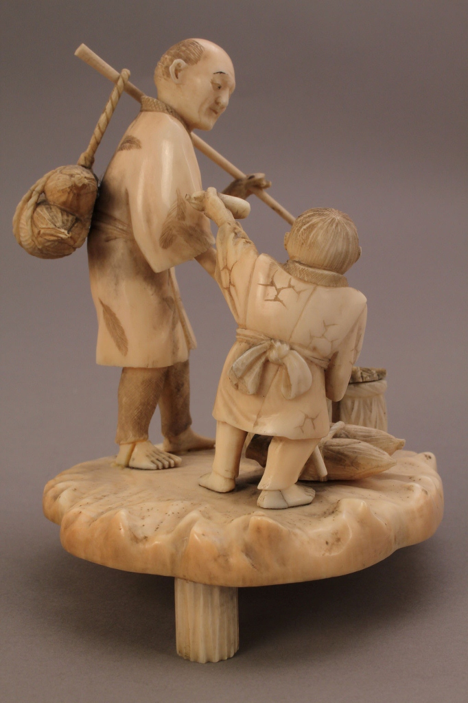 Lot 251: Ivory Okimono figure, man and boy working in the f