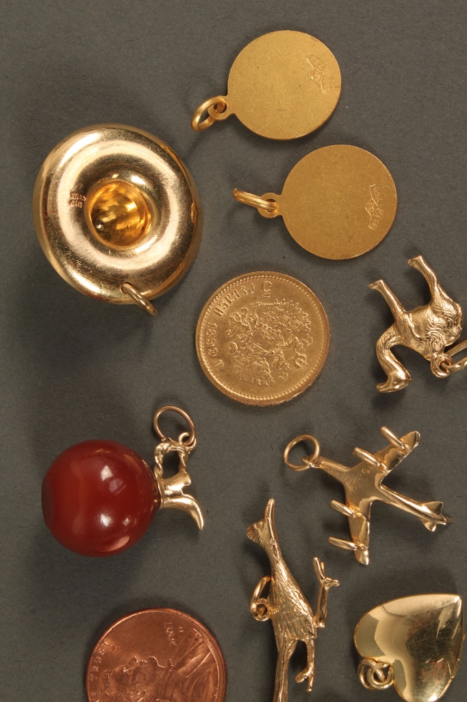Lot 395: Eleven 18K & 14K charms plus 1 coin