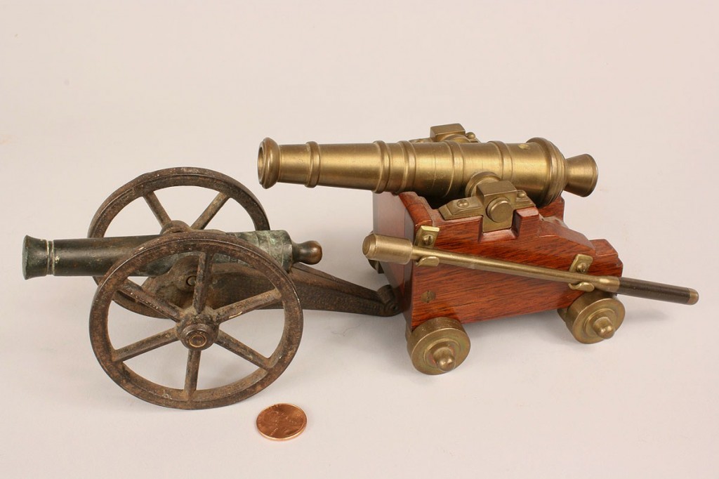 Lot 520: Four miniature firing cannons