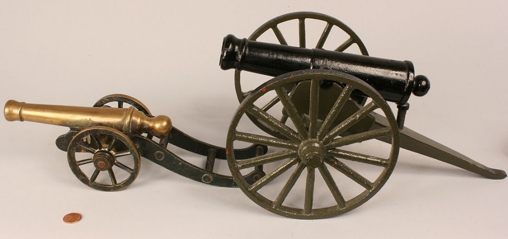 Lot 520: Four miniature firing cannons
