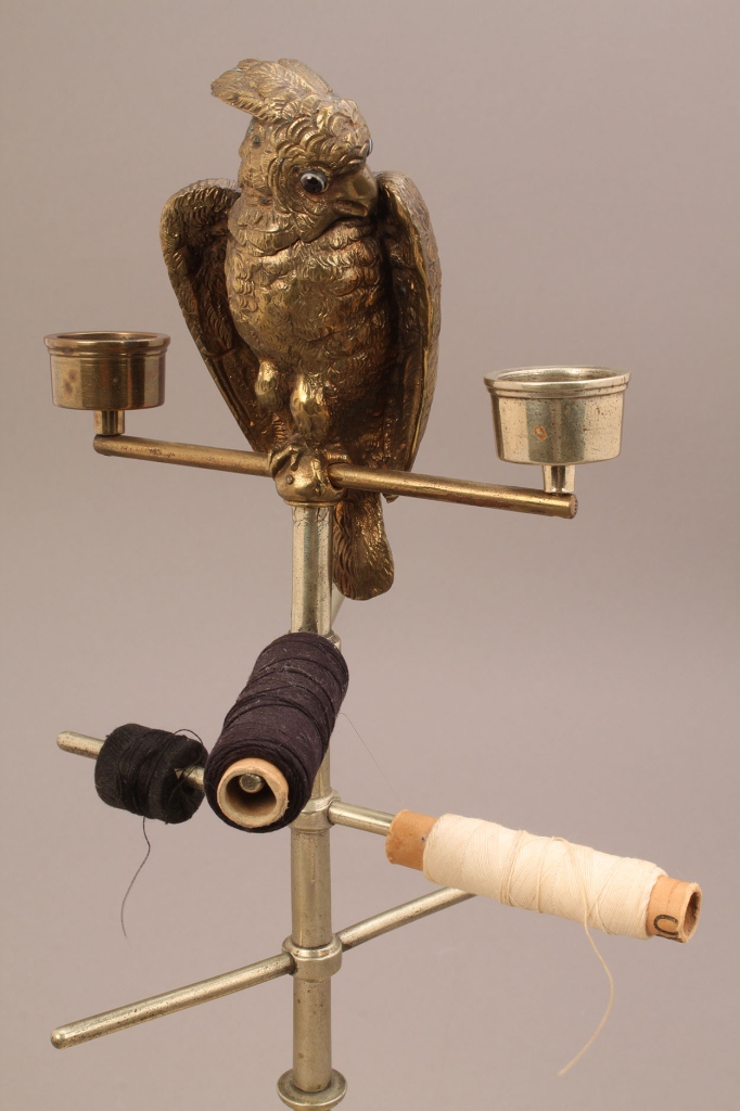 Lot 659: Sewing and candle caddy with figural parrot finial