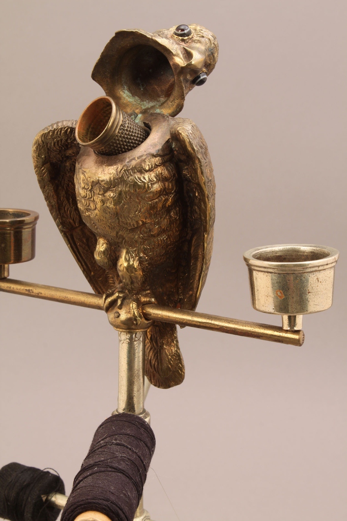 Lot 659: Sewing and candle caddy with figural parrot finial