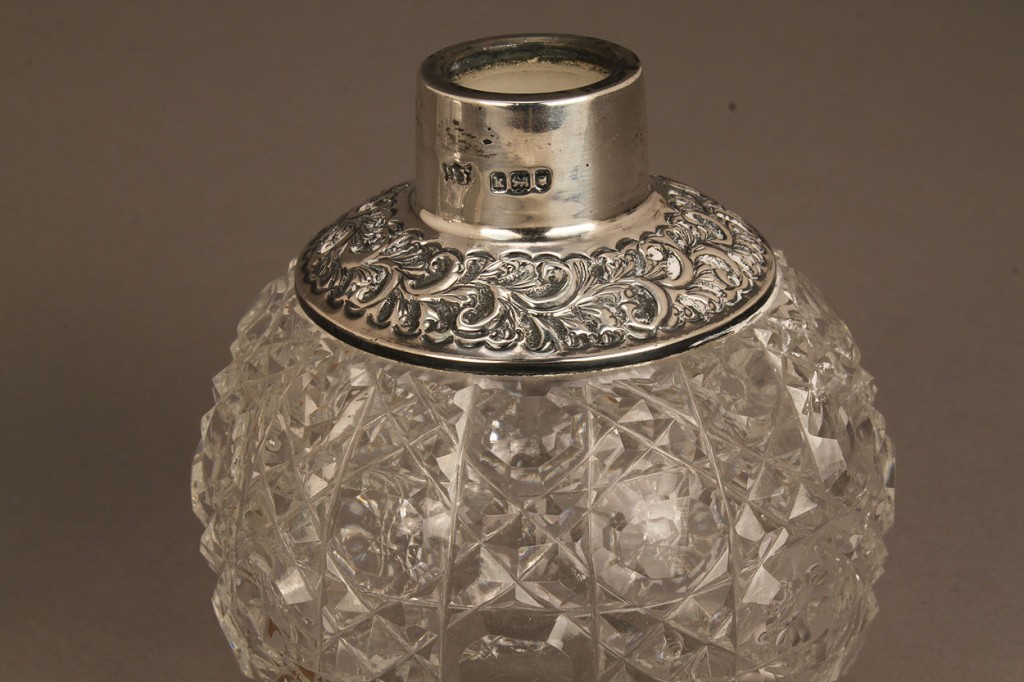 Lot 690: Three silver and glass perfume bottles